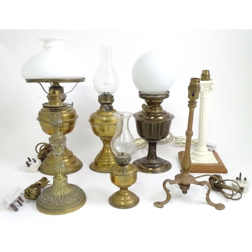 391 - A quantity of assorted table lamps, to include examples of oil lamp form, one formed as a Corinthian... 