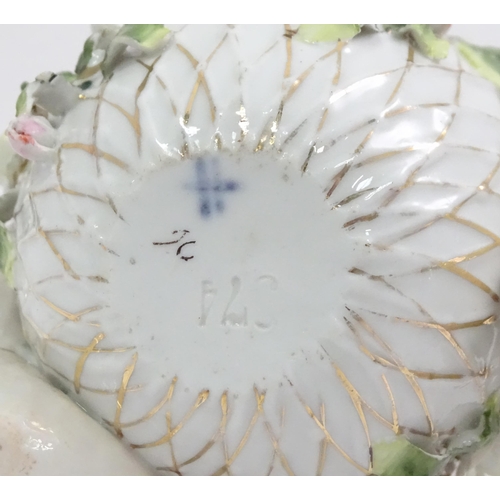 393 - A German porcelain basket with cherub and encrusted flower detail. Marked under with Sitzendorf styl... 