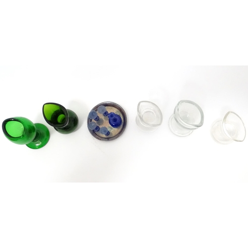 395 - A quantity of Victorian eyebaths to include green and clear glass examples. Together with a silver p... 
