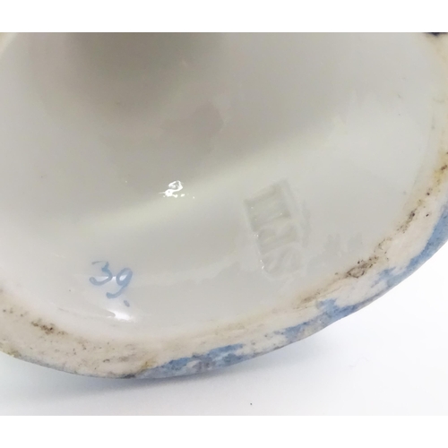 410 - A pair of German posy holders / bud vases of flower form with cherub detail. Impressed mark under SP... 