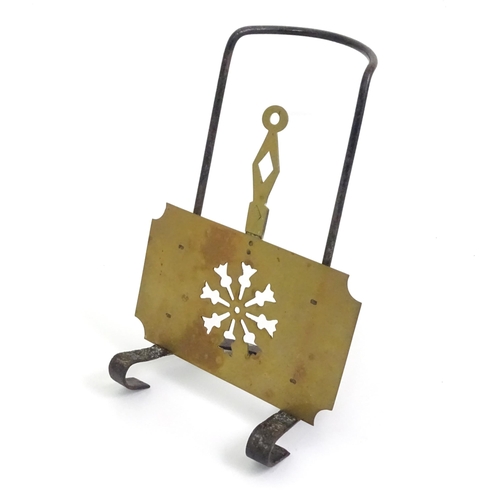 419 - A Victorian brass and cast iron sliding fireside trivet with hanging hooks and pierced detail. Appro... 