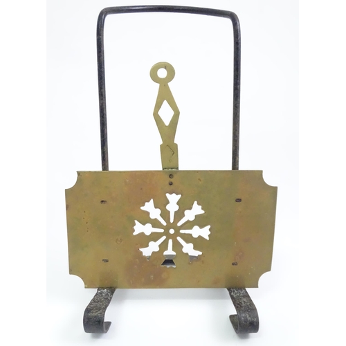 419 - A Victorian brass and cast iron sliding fireside trivet with hanging hooks and pierced detail. Appro... 