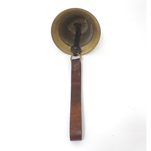 49 - A late 19thC brass hanging bell with leather strap, approx 5 1/2