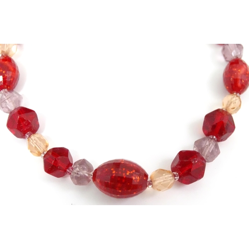 602 - A quantity of assorted costume jewellery to include a three strand bead necklace, a necklace with fa... 