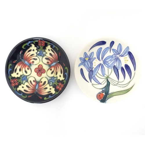 615 - Two Moorcroft pin dishes, one decorated in the pattern Fly Away Home Ladybird, the other with butter... 