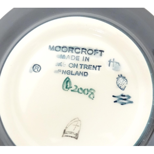 615 - Two Moorcroft pin dishes, one decorated in the pattern Fly Away Home Ladybird, the other with butter... 