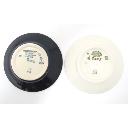 615 - Two Moorcroft pin dishes, one decorated in the pattern Fly Away Home Ladybird, the other with butter... 