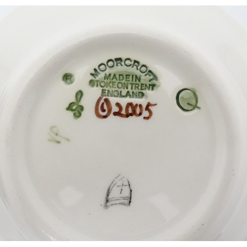 615 - Two Moorcroft pin dishes, one decorated in the pattern Fly Away Home Ladybird, the other with butter... 