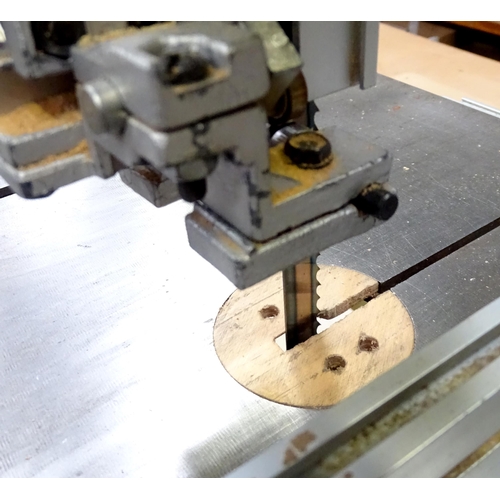 676 - Workshop Tools : a Perform 170mm bandsaw, with cupboard base containing accessories, spare blades et... 