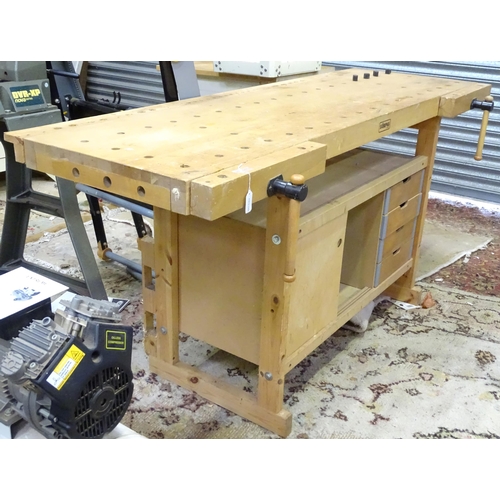 679 - Workshop Tools : A Sjobergs double workbench fitted with two vices. The base with shelf, cupboard an... 