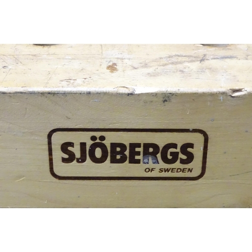 679 - Workshop Tools : A Sjobergs double workbench fitted with two vices. The base with shelf, cupboard an... 