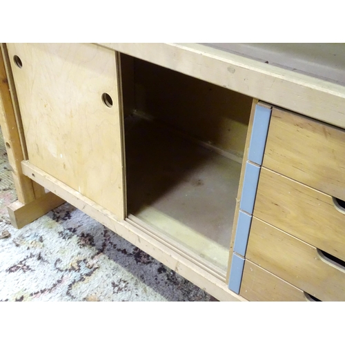 679 - Workshop Tools : A Sjobergs double workbench fitted with two vices. The base with shelf, cupboard an... 