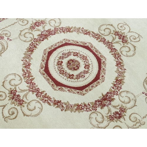 700 - Carpet / Rug : A cream ground rug with floral and acanthus detail within red ground borders. Approx ... 