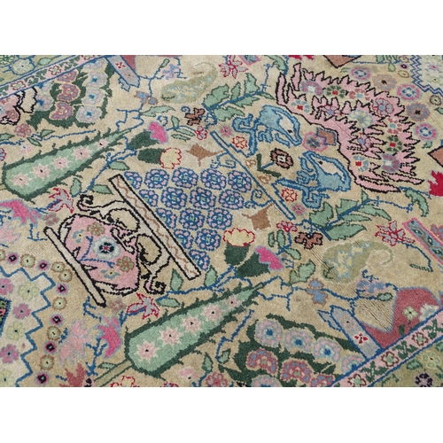 701 - Carpet / Rug : A cream and green ground rug profusely decorated with floral detail with vases, trees... 