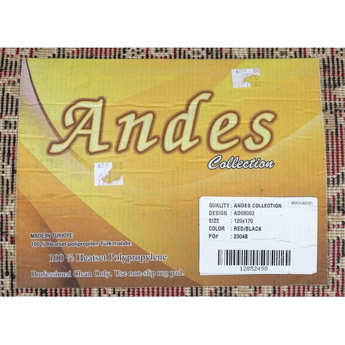 705 - Carpet / Rug : A red ground rug with floral and foliate detail. Approx 66