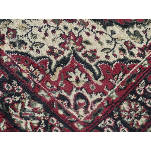 705 - Carpet / Rug : A red ground rug with floral and foliate detail. Approx 66