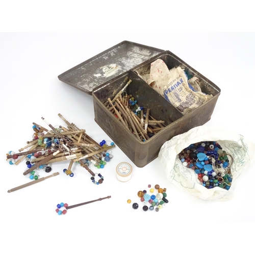 778 - A quantity of assorted 20thC turned wooden lace bobbins, many with decorative spangles. Contained wi... 