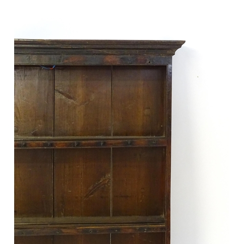 896 - An 18thC oak plate rack with a moulded cornice, shaped frieze and two cupboards. 74