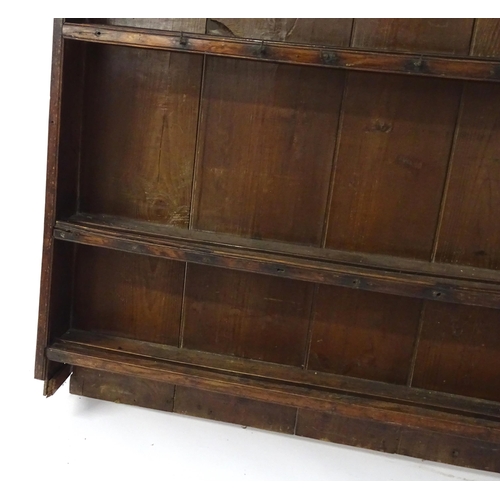 896 - An 18thC oak plate rack with a moulded cornice, shaped frieze and two cupboards. 74