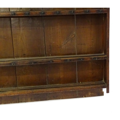 896 - An 18thC oak plate rack with a moulded cornice, shaped frieze and two cupboards. 74