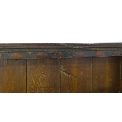 896 - An 18thC oak plate rack with a moulded cornice, shaped frieze and two cupboards. 74