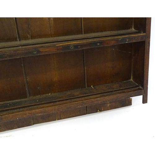 896 - An 18thC oak plate rack with a moulded cornice, shaped frieze and two cupboards. 74