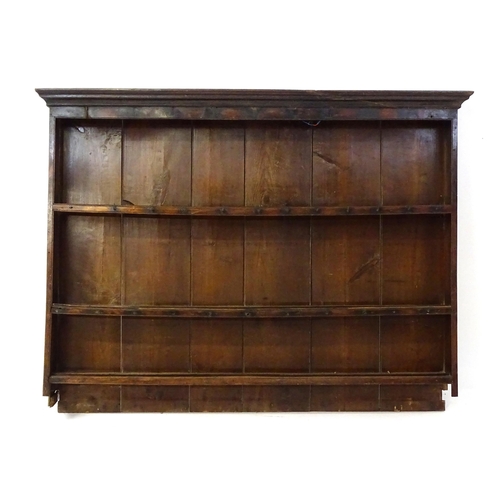 896 - An 18thC oak plate rack with a moulded cornice, shaped frieze and two cupboards. 74