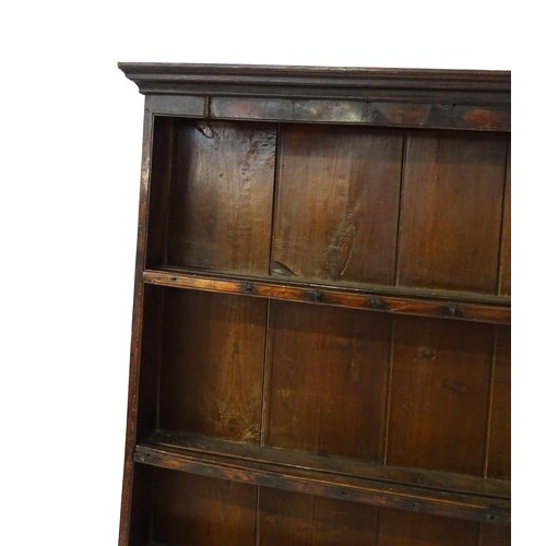 759 - An 18thC oak plate rack with a moulded cornice above three shelves. 64