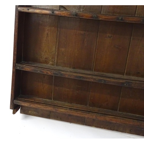 759 - An 18thC oak plate rack with a moulded cornice above three shelves. 64