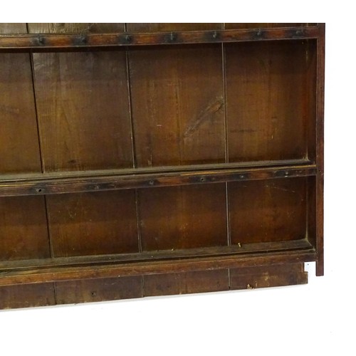 759 - An 18thC oak plate rack with a moulded cornice above three shelves. 64