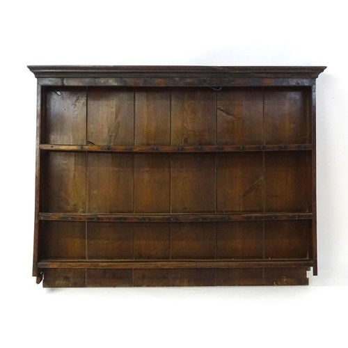 759 - An 18thC oak plate rack with a moulded cornice above three shelves. 64