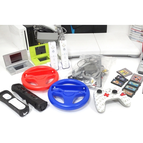 673 - Toys: Two Nintendo Wii games consoles and accessories to include Wii controllers, balance board, var... 