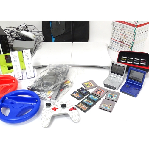 673 - Toys: Two Nintendo Wii games consoles and accessories to include Wii controllers, balance board, var... 