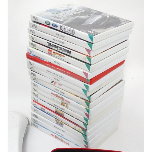 673 - Toys: Two Nintendo Wii games consoles and accessories to include Wii controllers, balance board, var... 