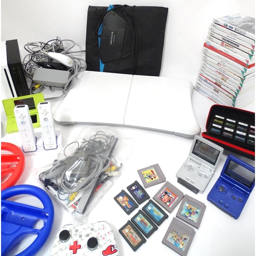 673 - Toys: Two Nintendo Wii games consoles and accessories to include Wii controllers, balance board, var... 