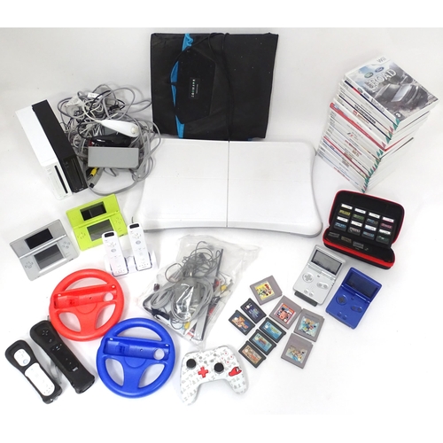 673 - Toys: Two Nintendo Wii games consoles and accessories to include Wii controllers, balance board, var... 