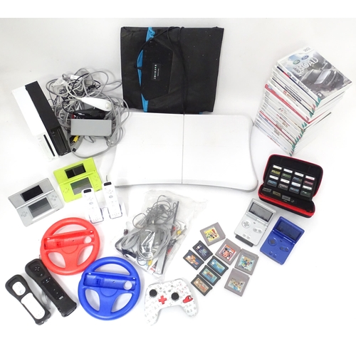 673 - Toys: Two Nintendo Wii games consoles and accessories to include Wii controllers, balance board, var... 