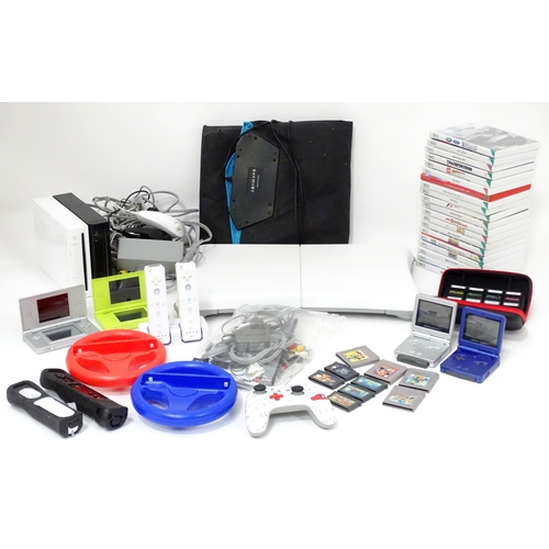 673 - Toys: Two Nintendo Wii games consoles and accessories to include Wii controllers, balance board, var... 