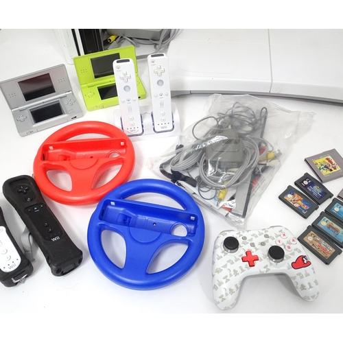 673 - Toys: Two Nintendo Wii games consoles and accessories to include Wii controllers, balance board, var... 