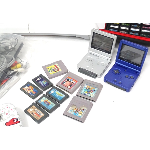 673 - Toys: Two Nintendo Wii games consoles and accessories to include Wii controllers, balance board, var... 