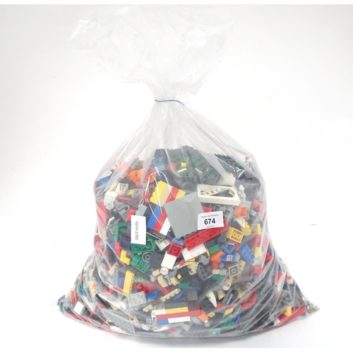 674 - Toys: A quantity of Lego to include bricks, wheels and figures etc.