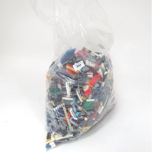 694 - A quantity of Lego to include bricks, wheels and figures etc.