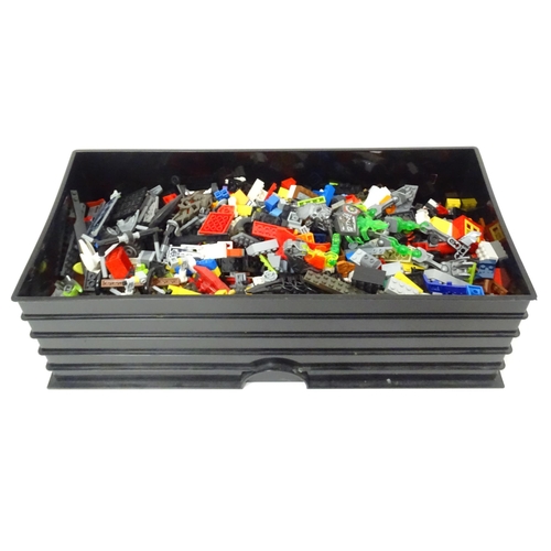 772 - Toys: A quantity of Lego to include bricks, wheels and figures etc. Within a Lego brick storage box.