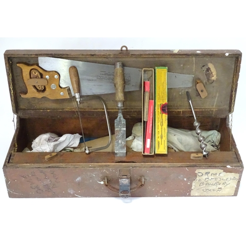 632 - A carpenter's fitted tool chest containing a quantity of hand tools, to include saws, drill bits, ch... 