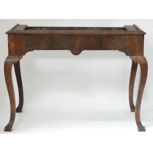 656 - An 18thC walnut cabinet / chest stand, the carved apron standing on four shaped cabriole legs, appro... 