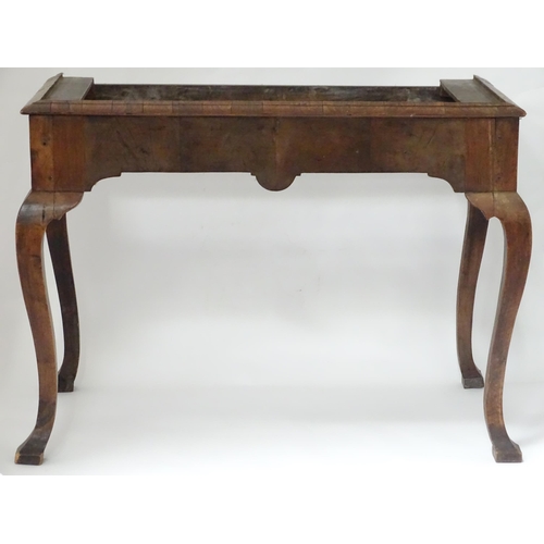 656 - An 18thC walnut cabinet / chest stand, the carved apron standing on four shaped cabriole legs, appro... 