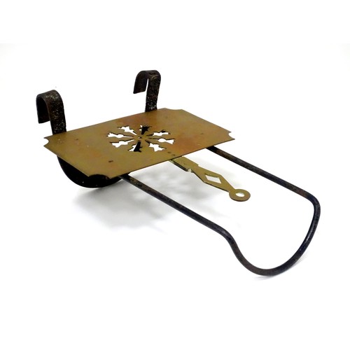 419 - A Victorian brass and cast iron sliding fireside trivet with hanging hooks and pierced detail. Appro... 