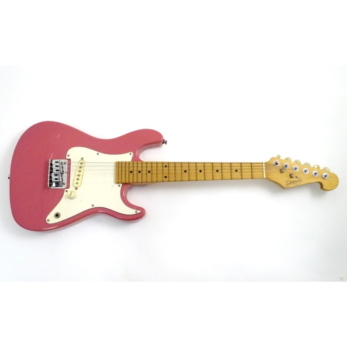222 - A student's 3/4 size electric guitar by Jasmin, in pink finish with double cutaway contoured body, s... 