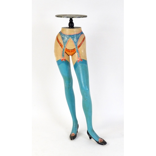 86 - A late 20thC stand raised on a model / mannequin of a woman's legs with painted lingerie detail. 49