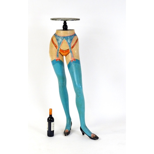 86 - A late 20thC stand raised on a model / mannequin of a woman's legs with painted lingerie detail. 49